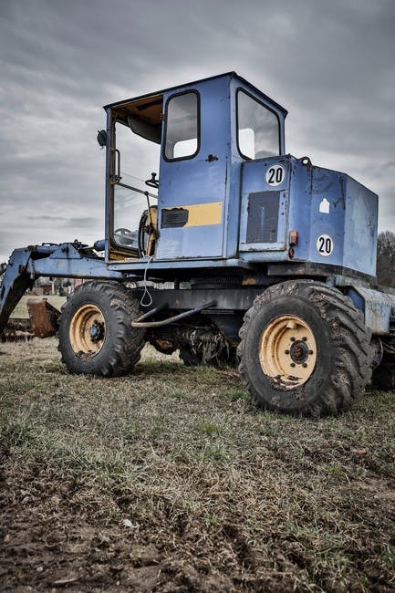 Blue and Black Tractor in Green Grass