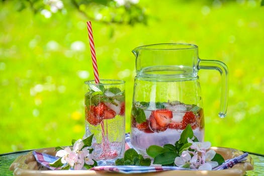 Clear Glass Pitcher With Water and Strawberry