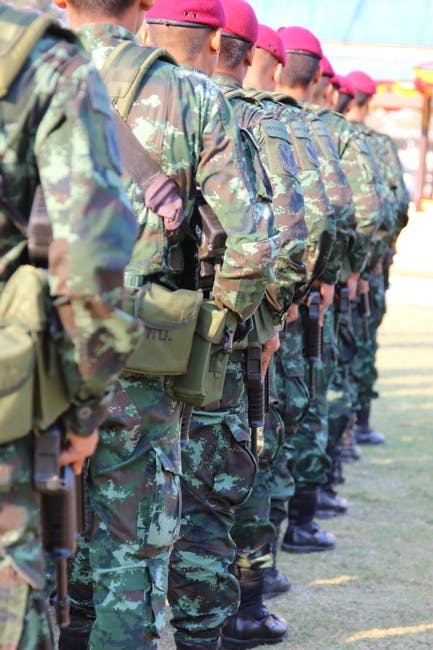 People Wearing Green and Brown Camouflage Military Suit While Standing ...