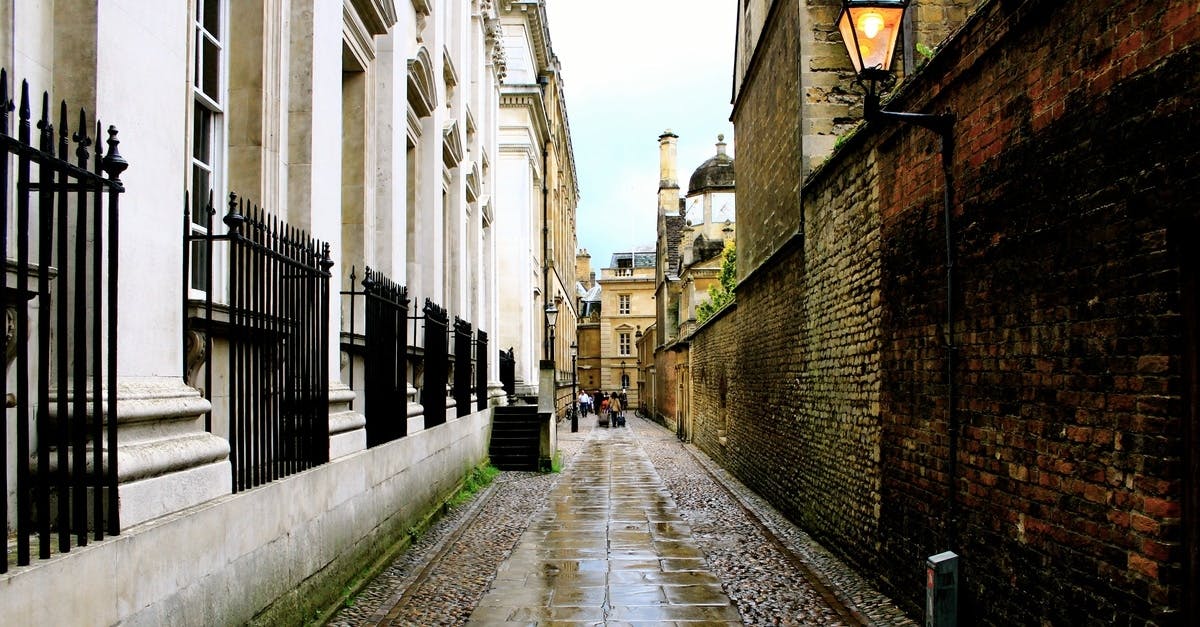 brown-concrete-road-in-the-middle-of-buildings-free-stock-photo