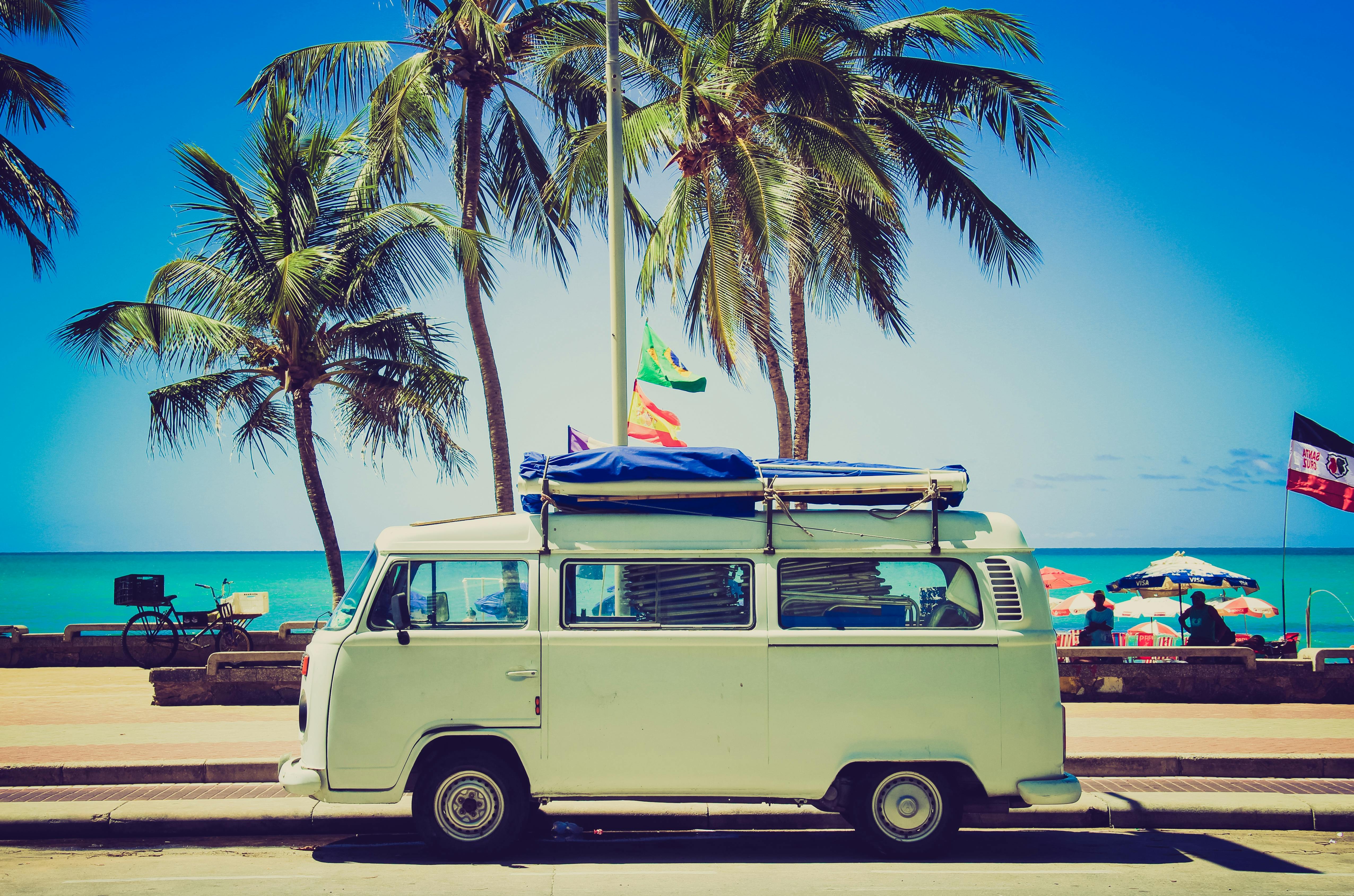 A VW van packed and parked with the best apps for your summer road trip.