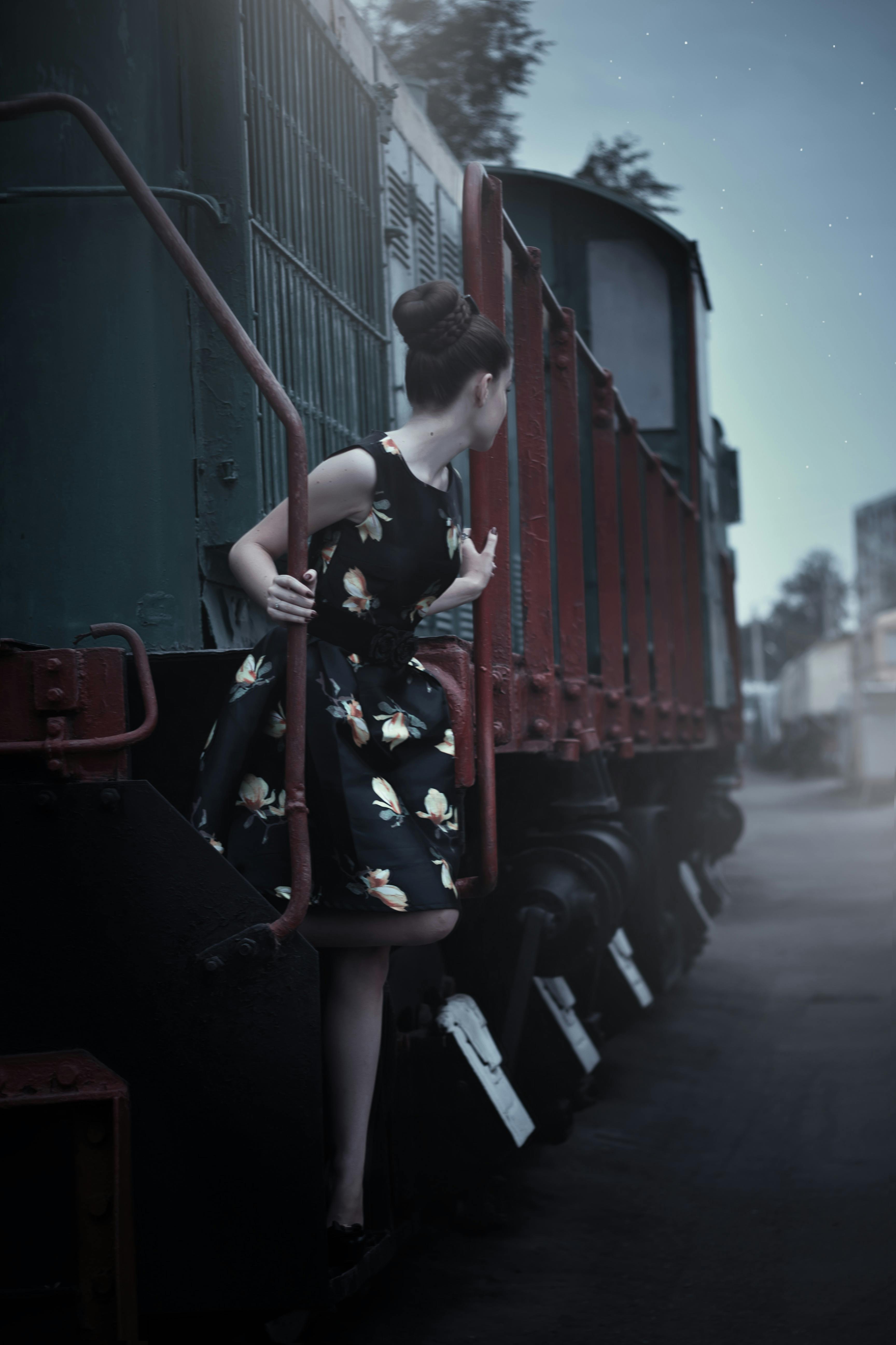Woman in Black Sleeveless Dress Standing Beside Train \u00b7 Free Stock Photo