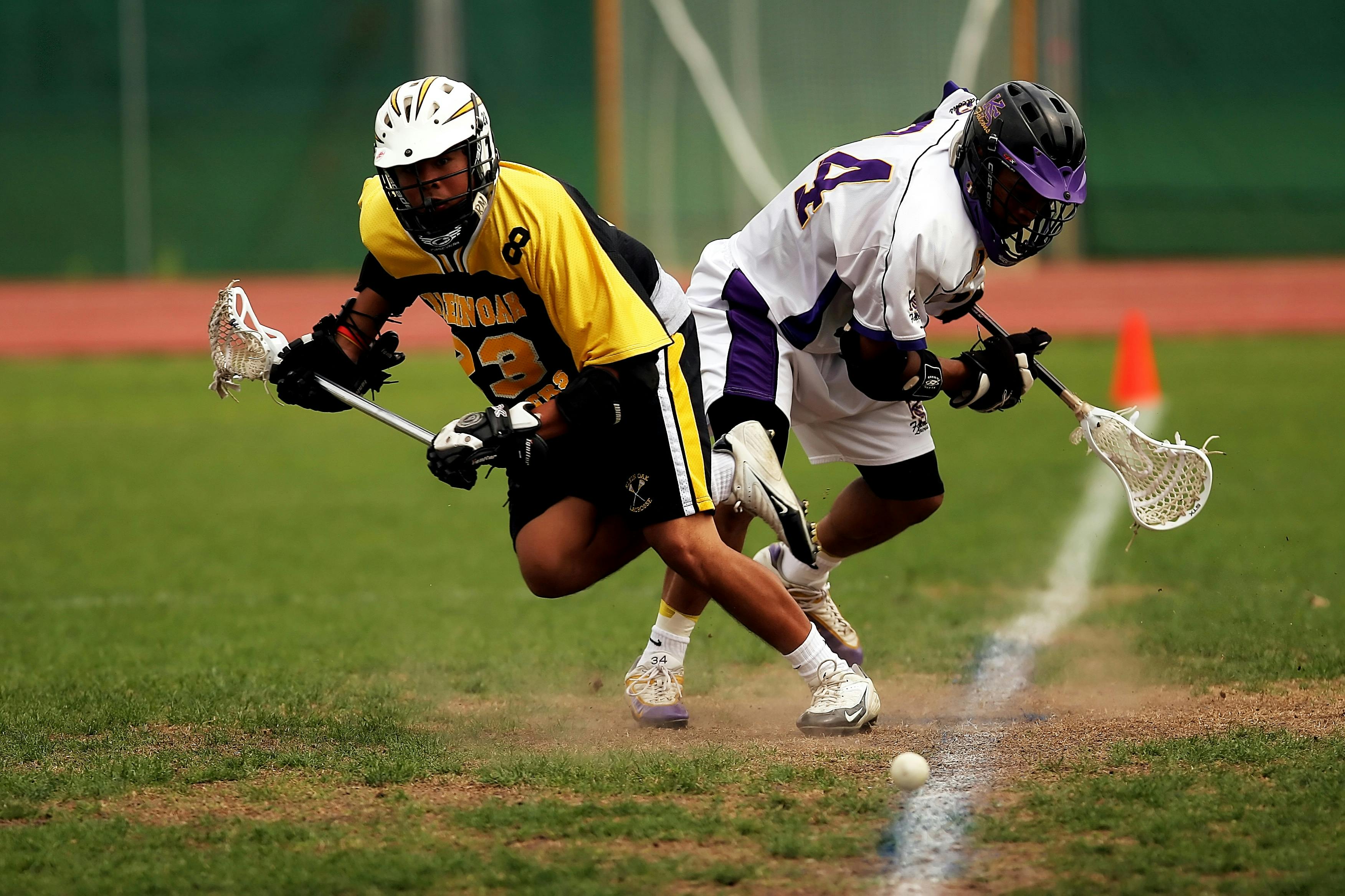 Man Wearing Yellow and Black Sport Jersey Holding Lacrosse Stick · Free