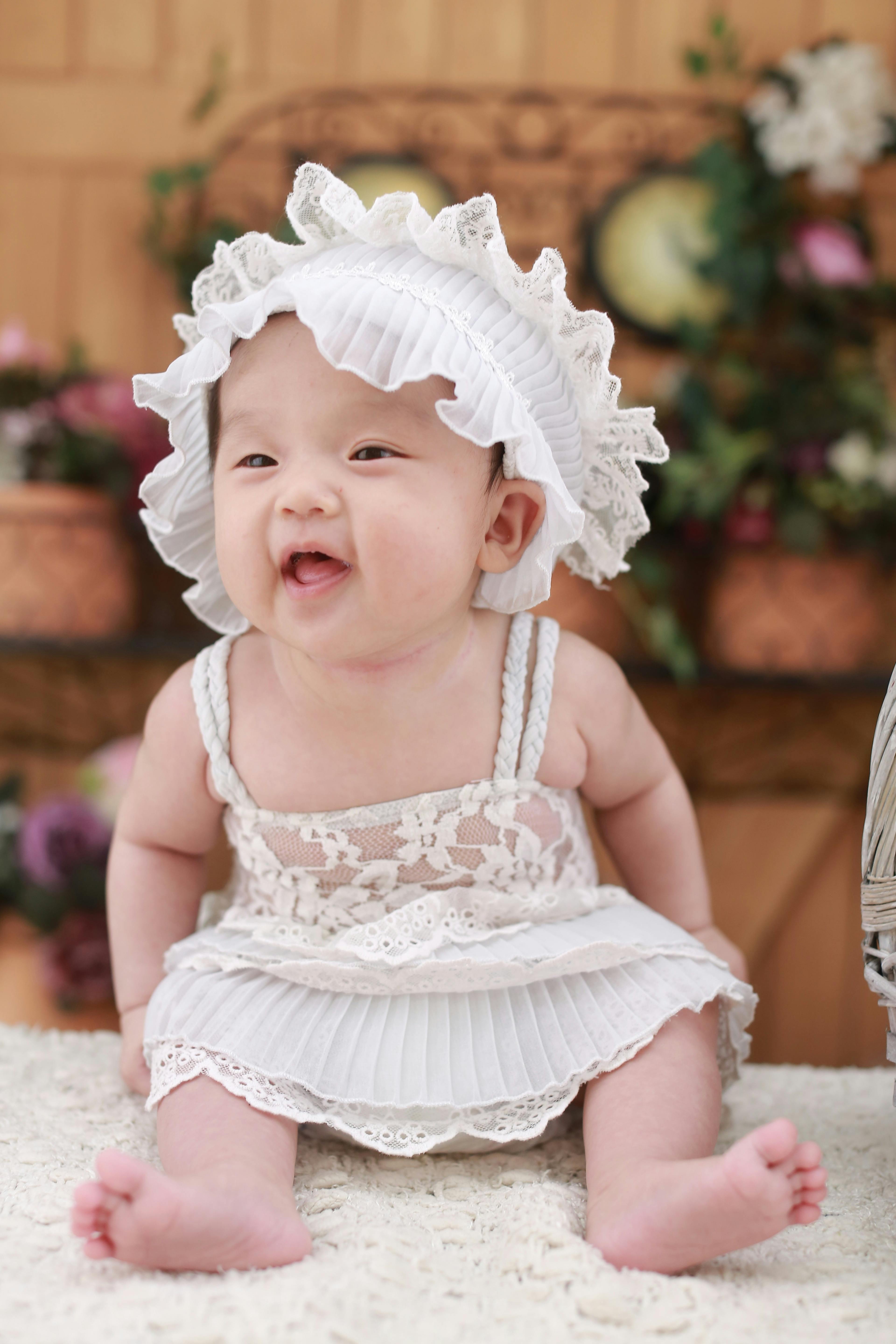 Baby in White Dress With White Headdress · Free Stock Photo