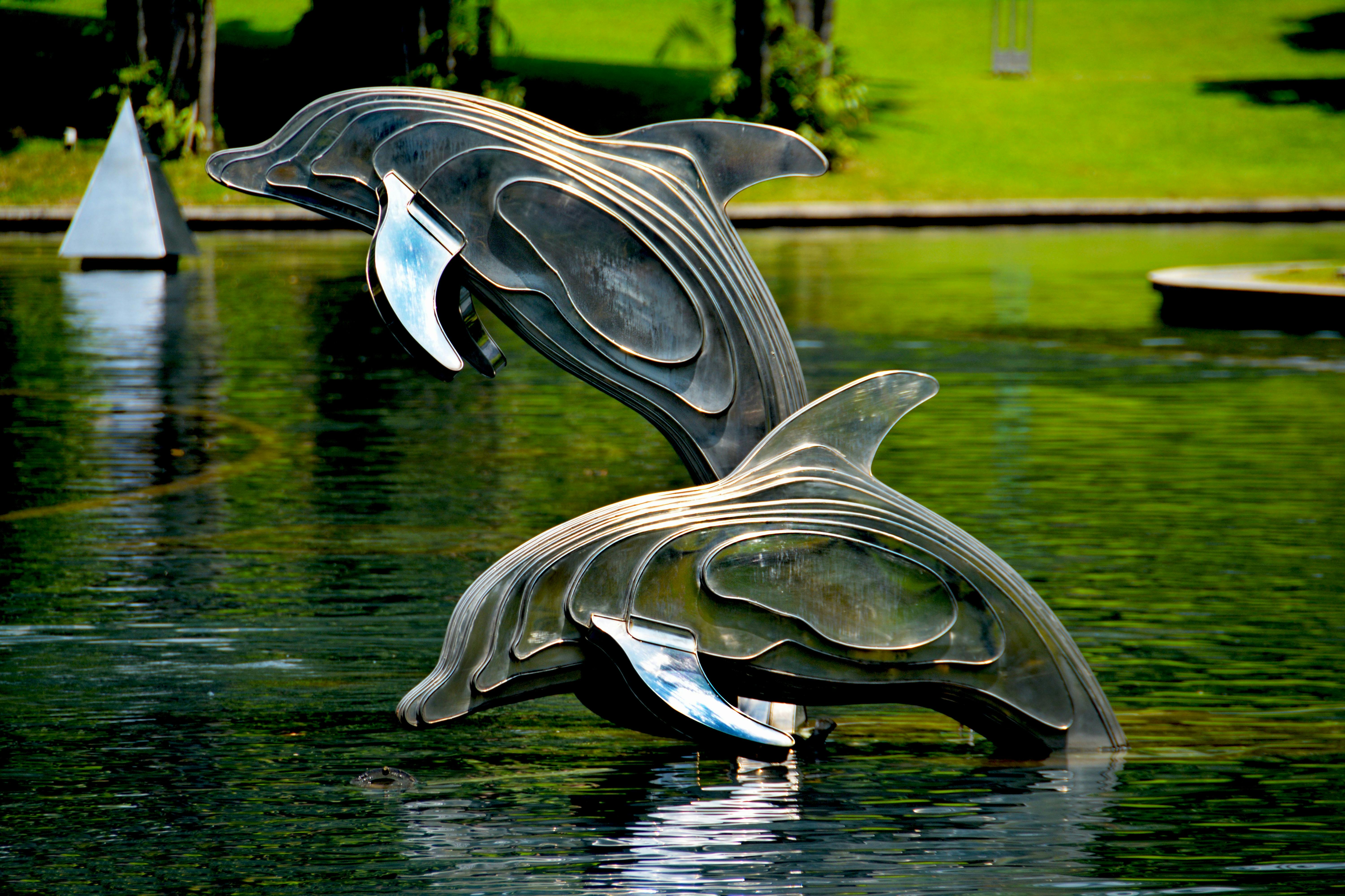 Gray and Brass Metal Dolphin Pool Decor · Free Stock Photo