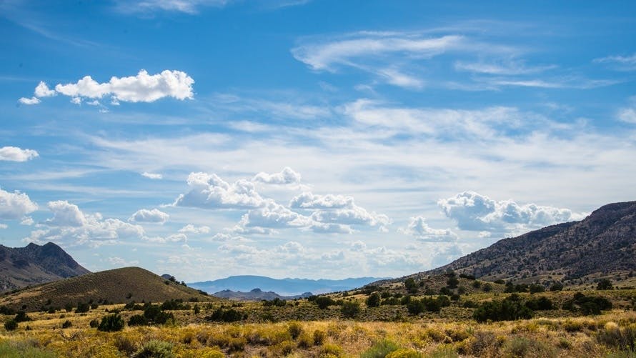 Free stock photo of Blue sky and clouds with desert hills