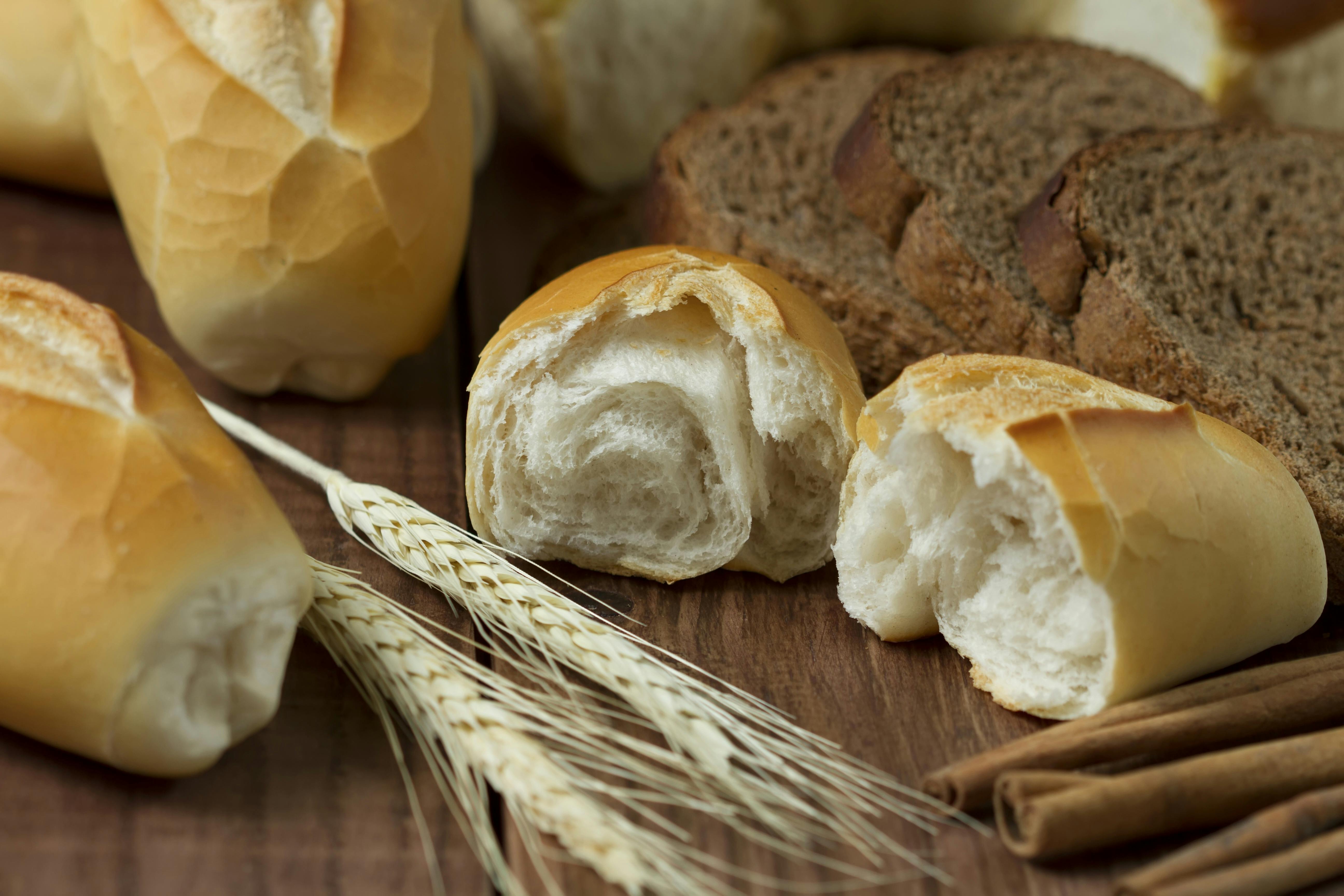 Sliced Bread Beside Wheat On Table · Free Stock Photo