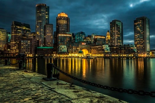 Lighted City Skylines under Deep Blue Sky during Night