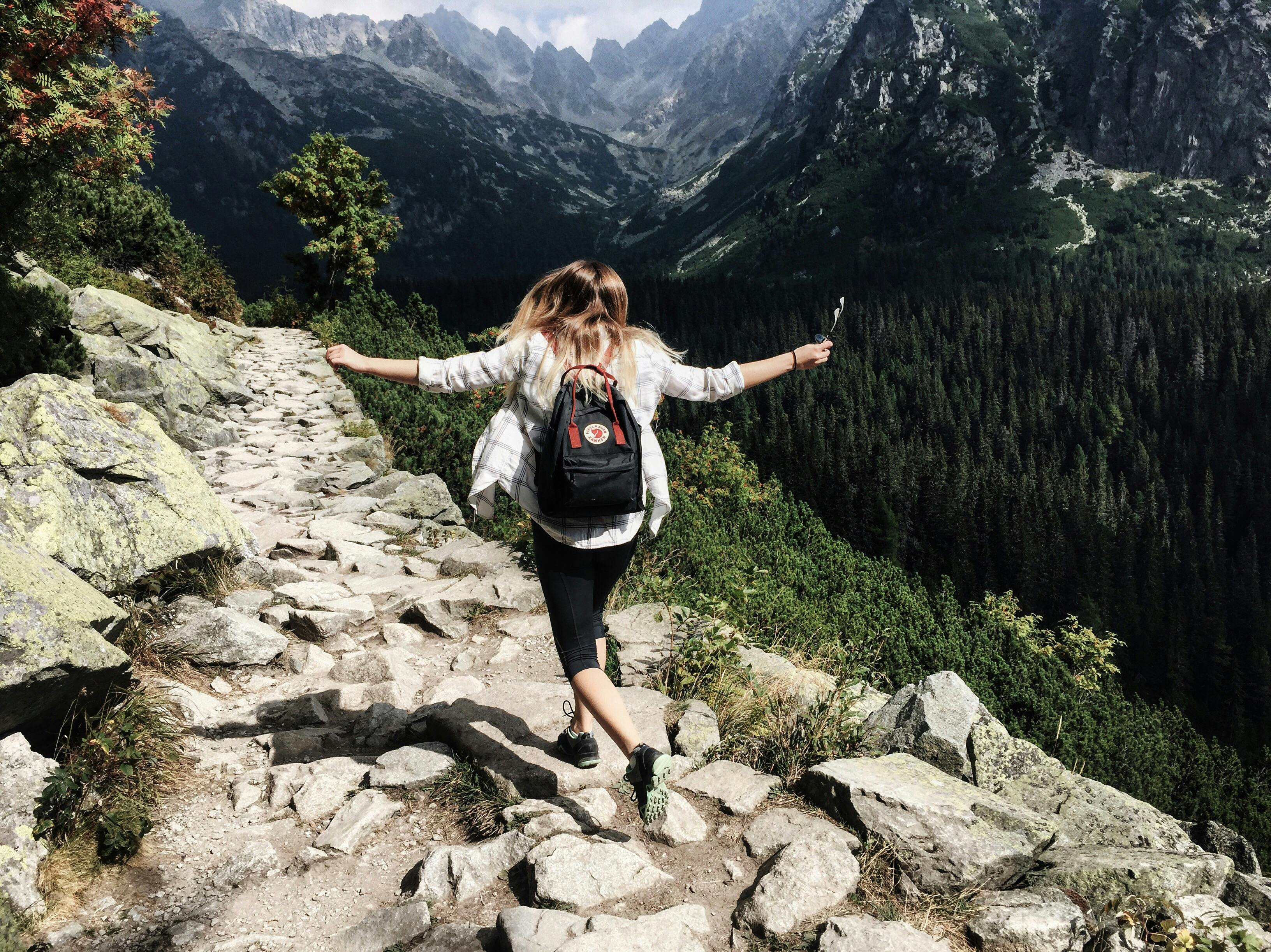 Backpacking woman hiking through nature