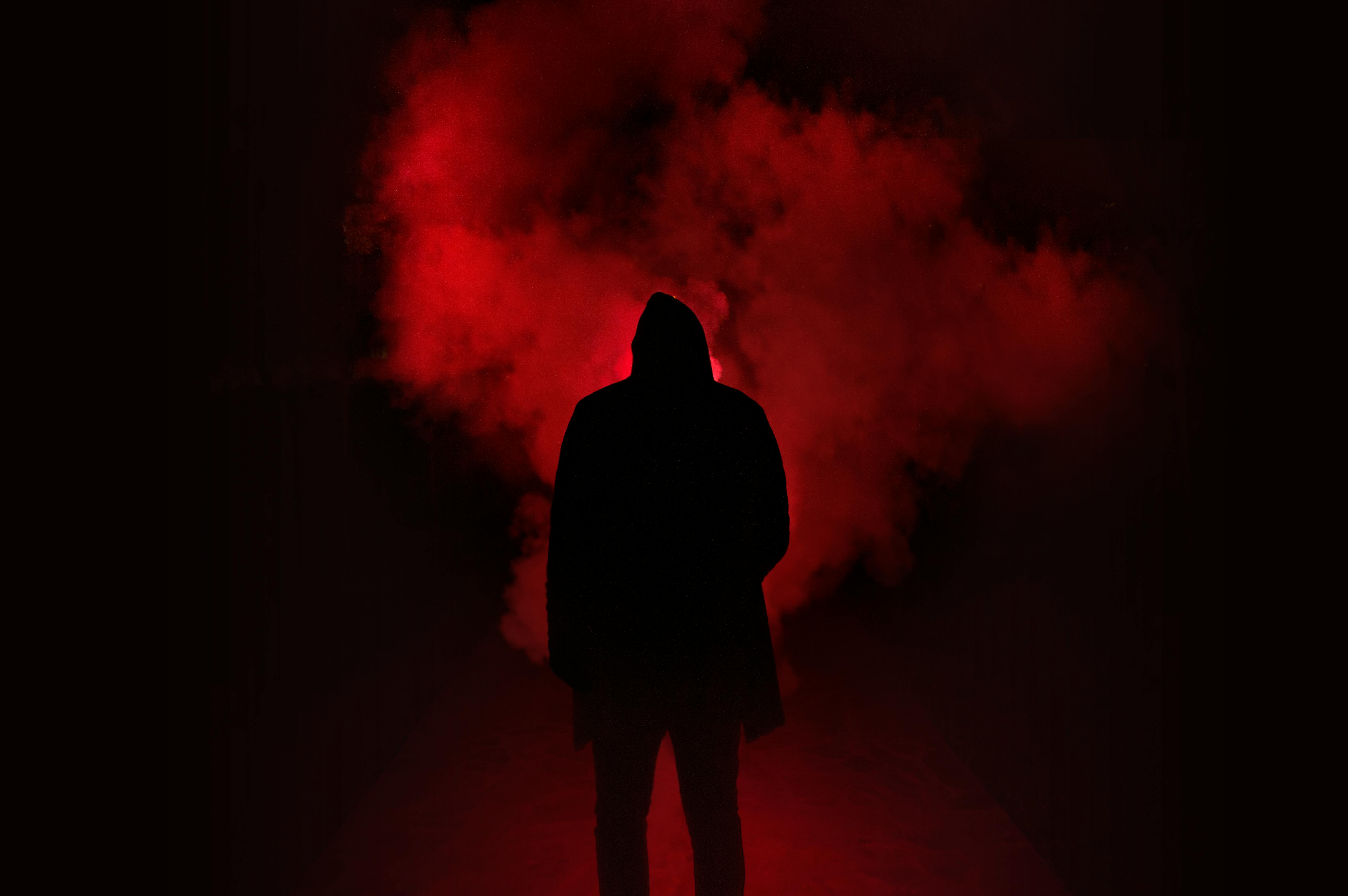 Silhouette Of Man Standing Against Black And Red Background Free