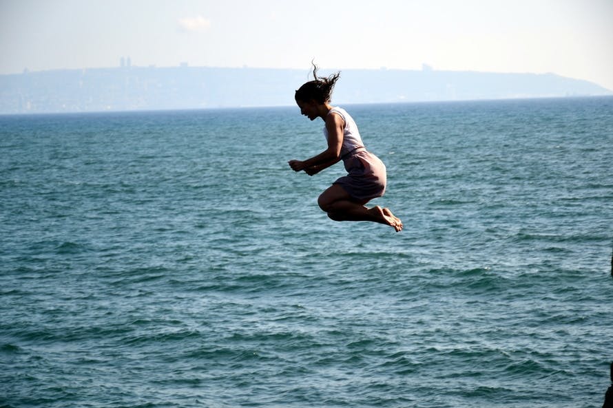Free stock photo of jump, sea, woman