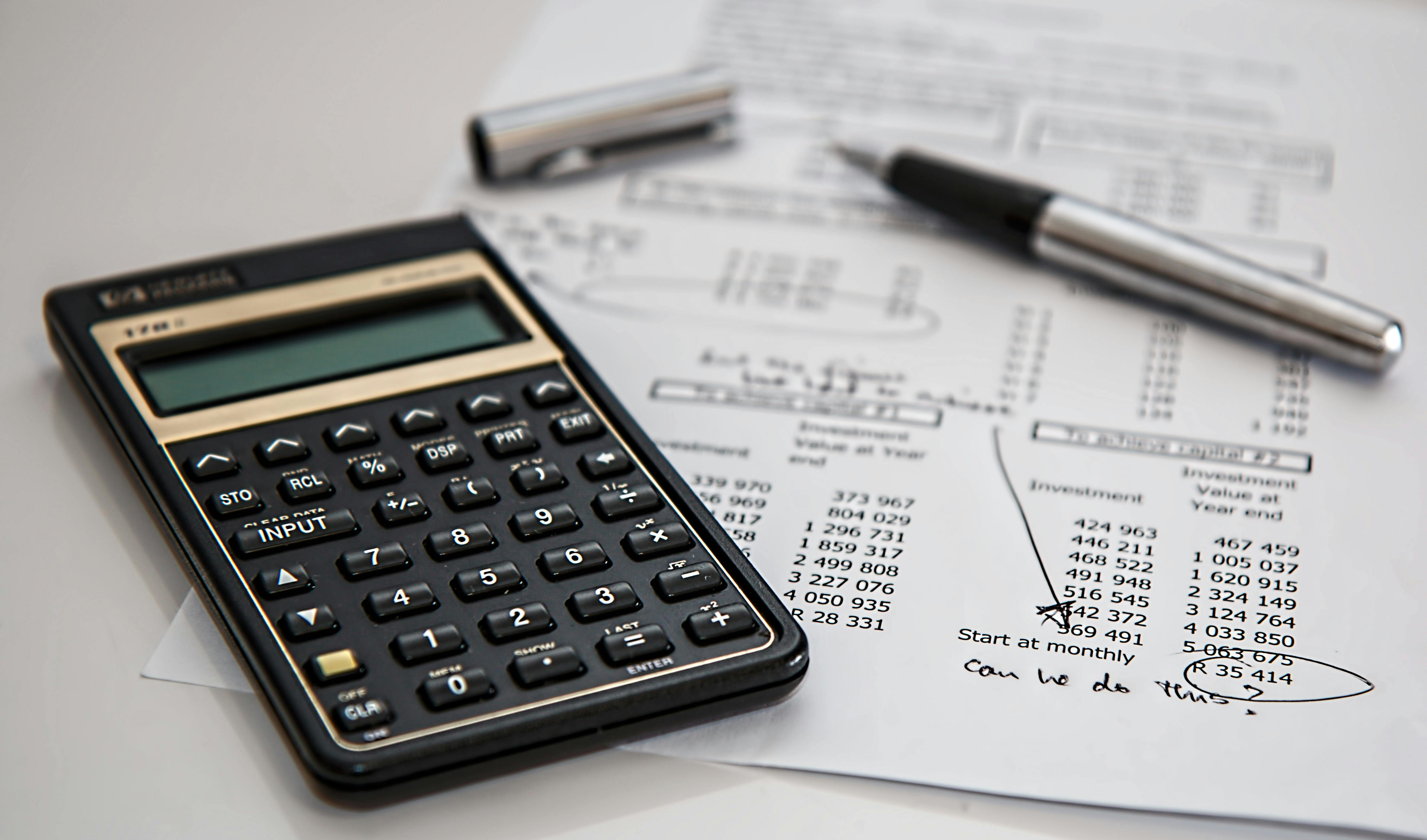 A calculator sits next to a financial statement.