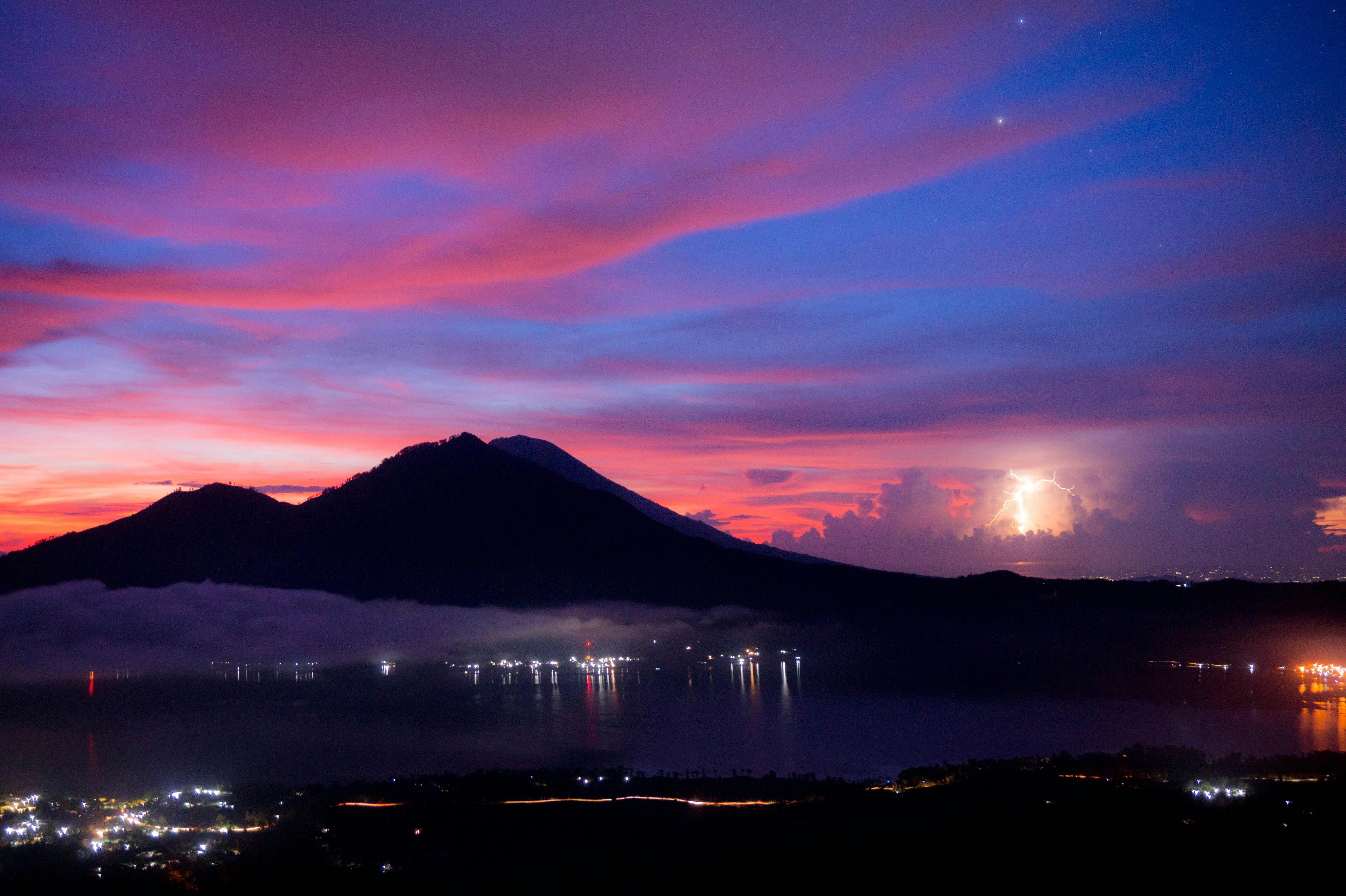 Mountain Beside Body of Water during Sunset  Free Stock Photo