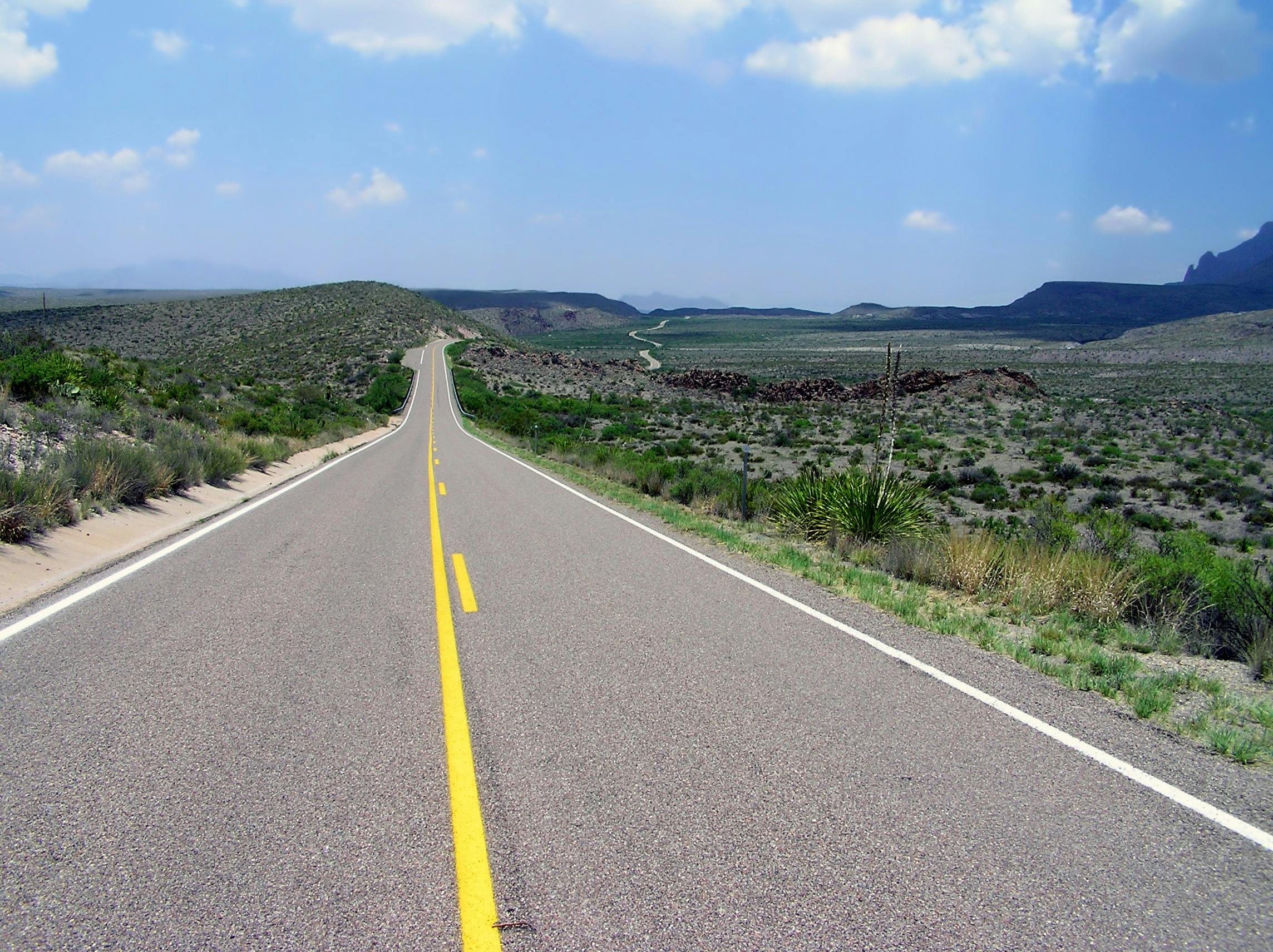 gray-concrete-road-with-white-safety-line-during-daytime-free-stock-photo