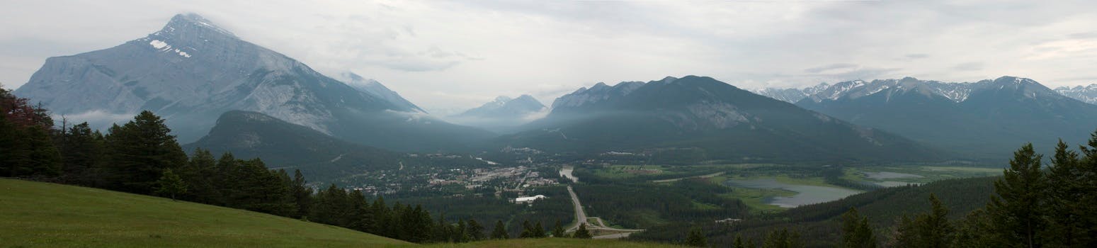 Mountains in the Background and Green Meadows during Daytime