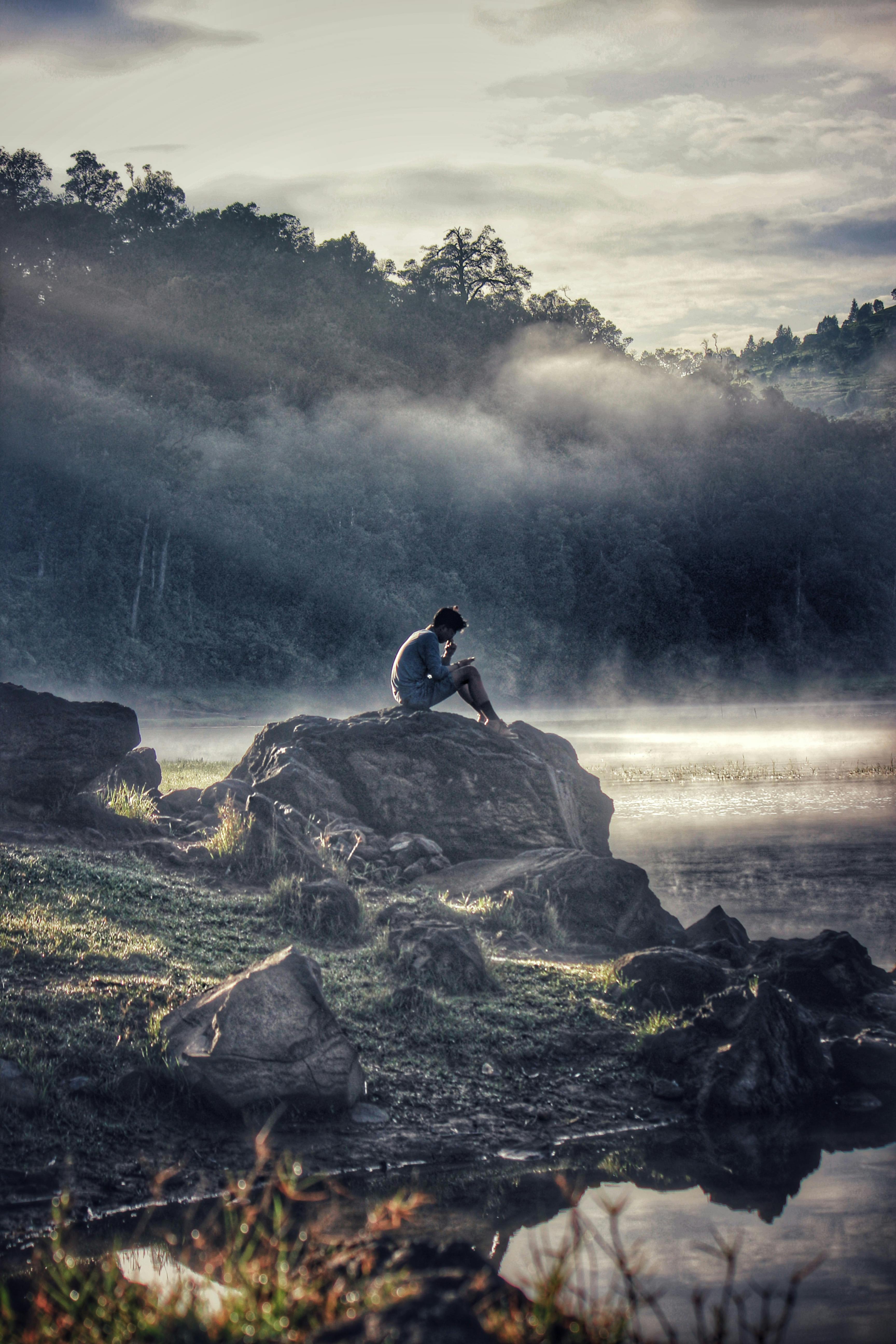 Man in Gray Shit Sitting on Rock Boulder · Free Stock Photo