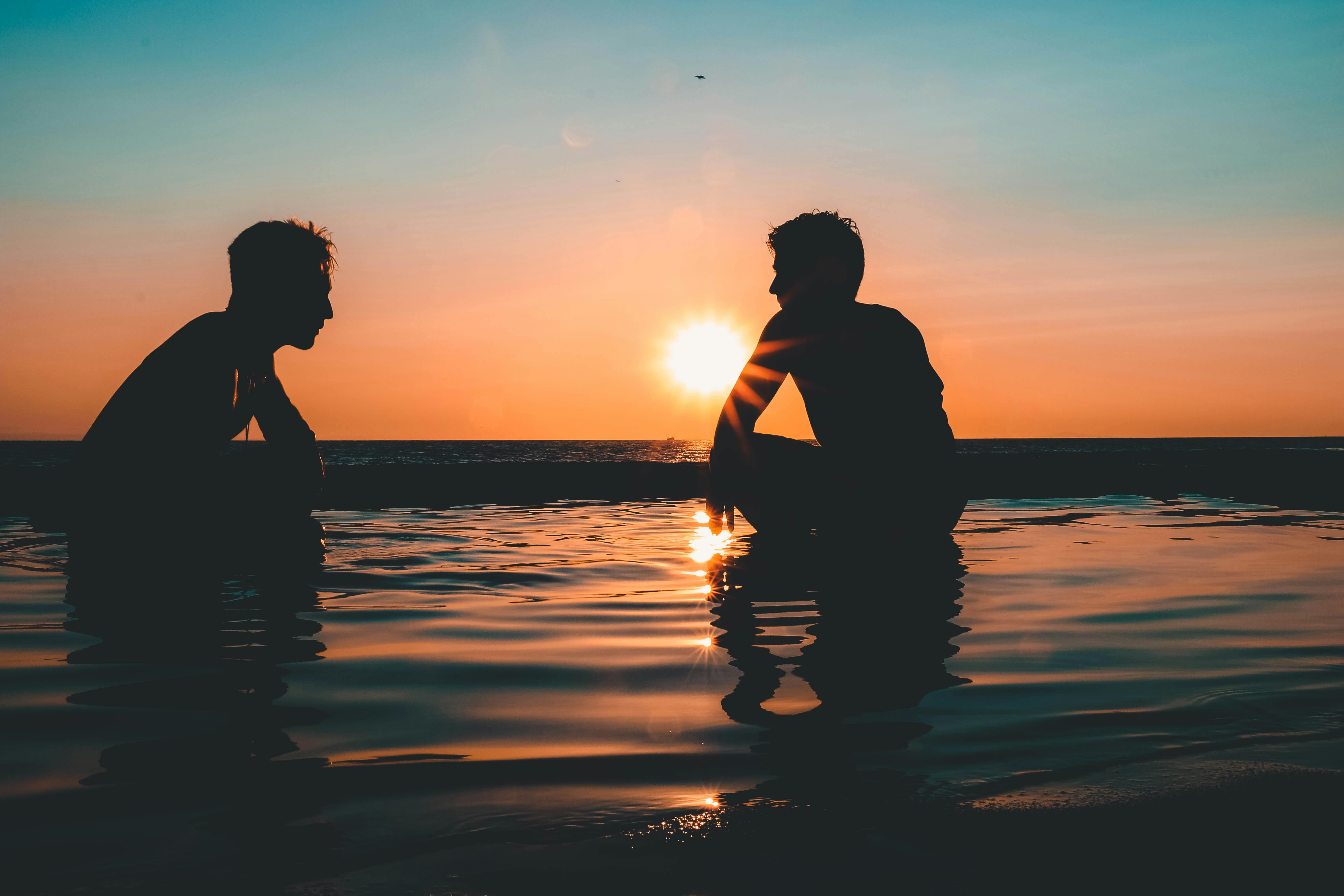 Photo of Two Men on Seashore during Sunset · Free Stock Photo