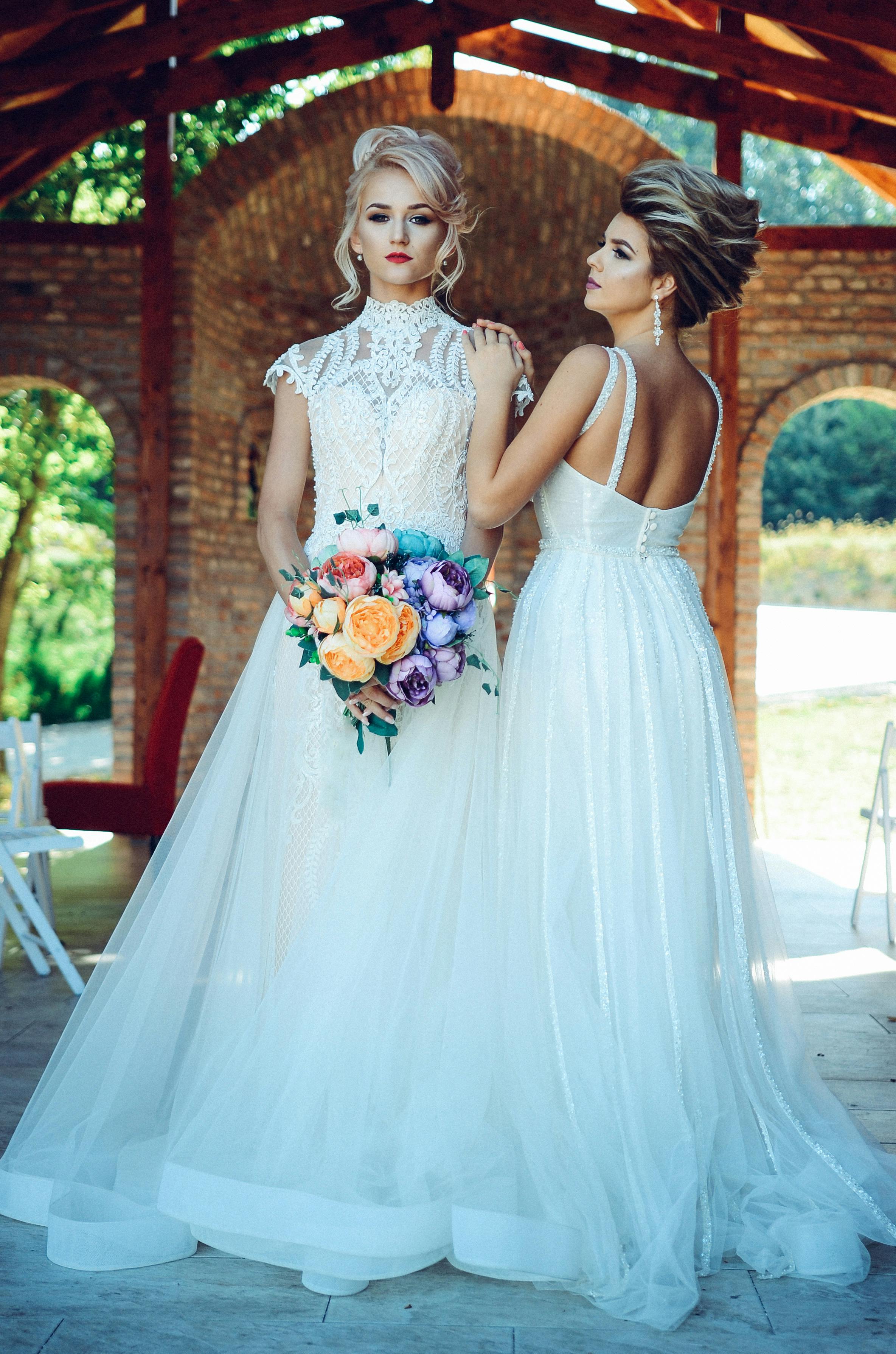 Woman in White Lace Wedding Dress Holding Flower Bouquet 