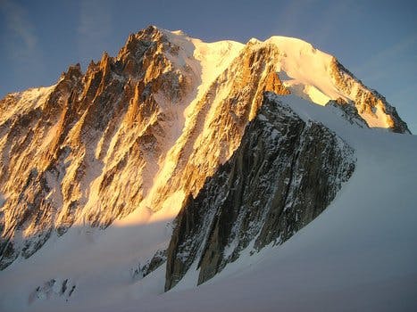 Grey Mountain Filled With Snow Under Grey Sky