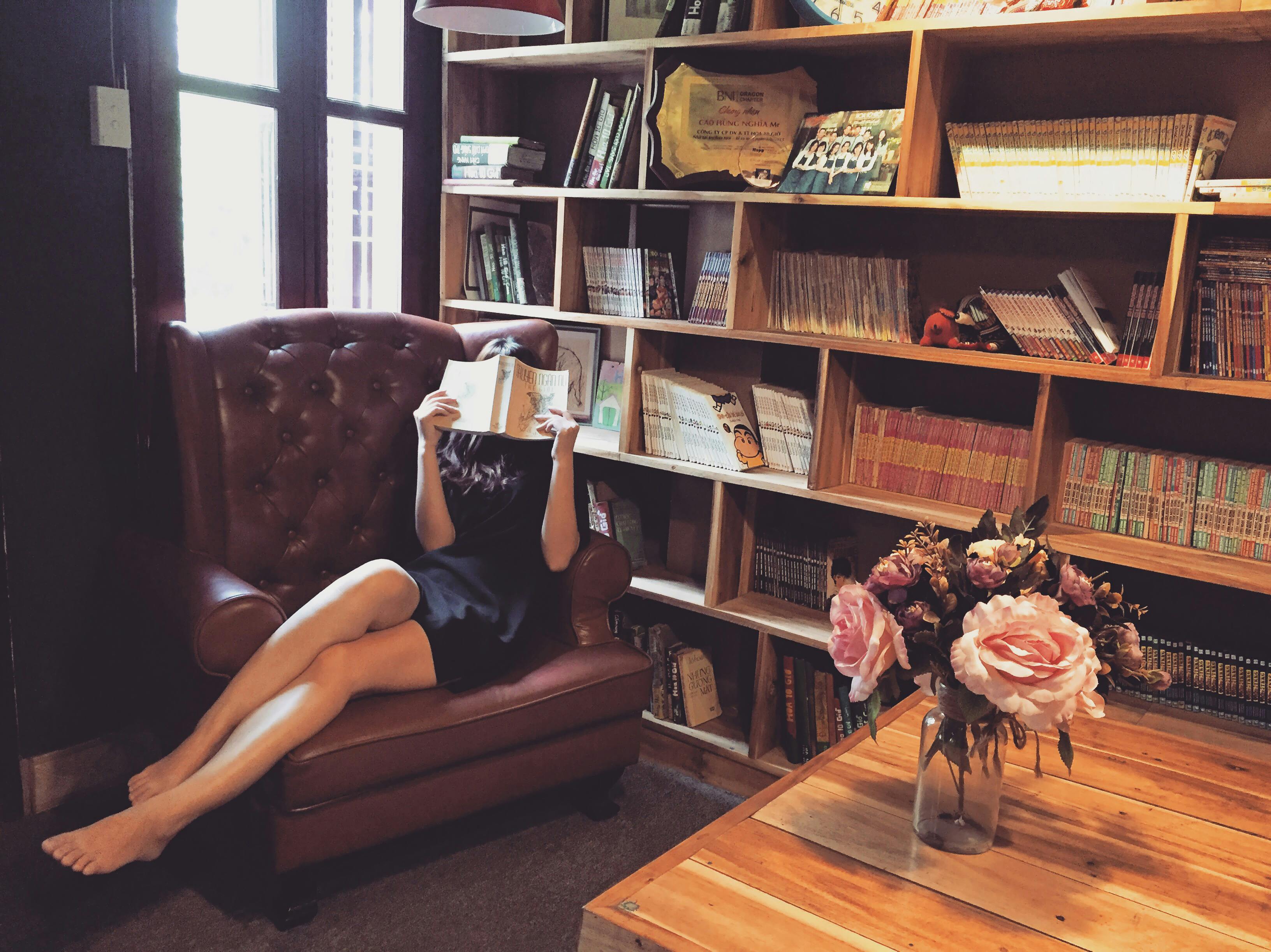 woman reading in leather chair