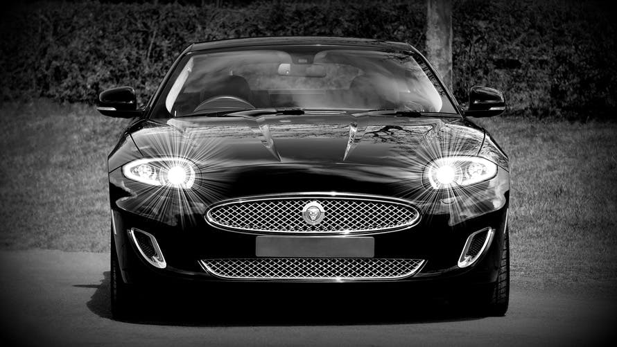Grayscale Photo of a Black Sports Car Convertible
