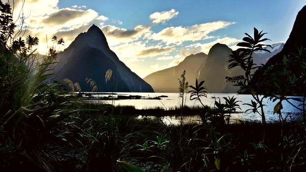 Mountains on Sea during Day Time