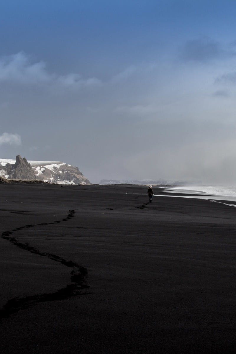 Black Sand Seashore Beside Snow Covered Mountain · Free Stock Photo